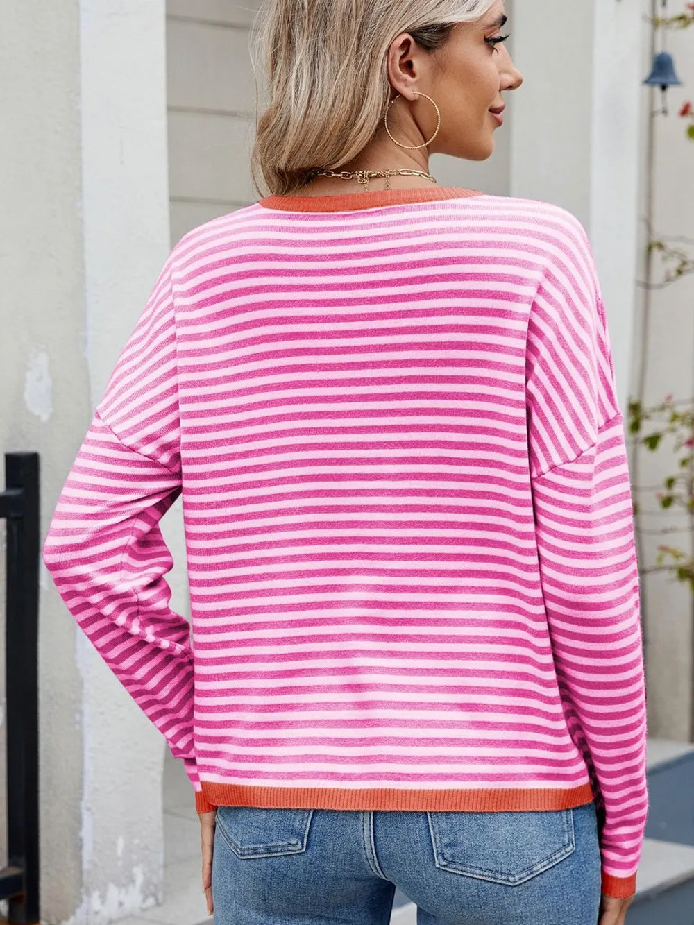Striped contrast round-neck long-sleeve sweater, back view, pink and white stripes with orange trim