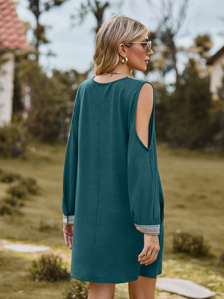 Teal V-neck mini dress with cutout shoulders and embroidered cuff trim