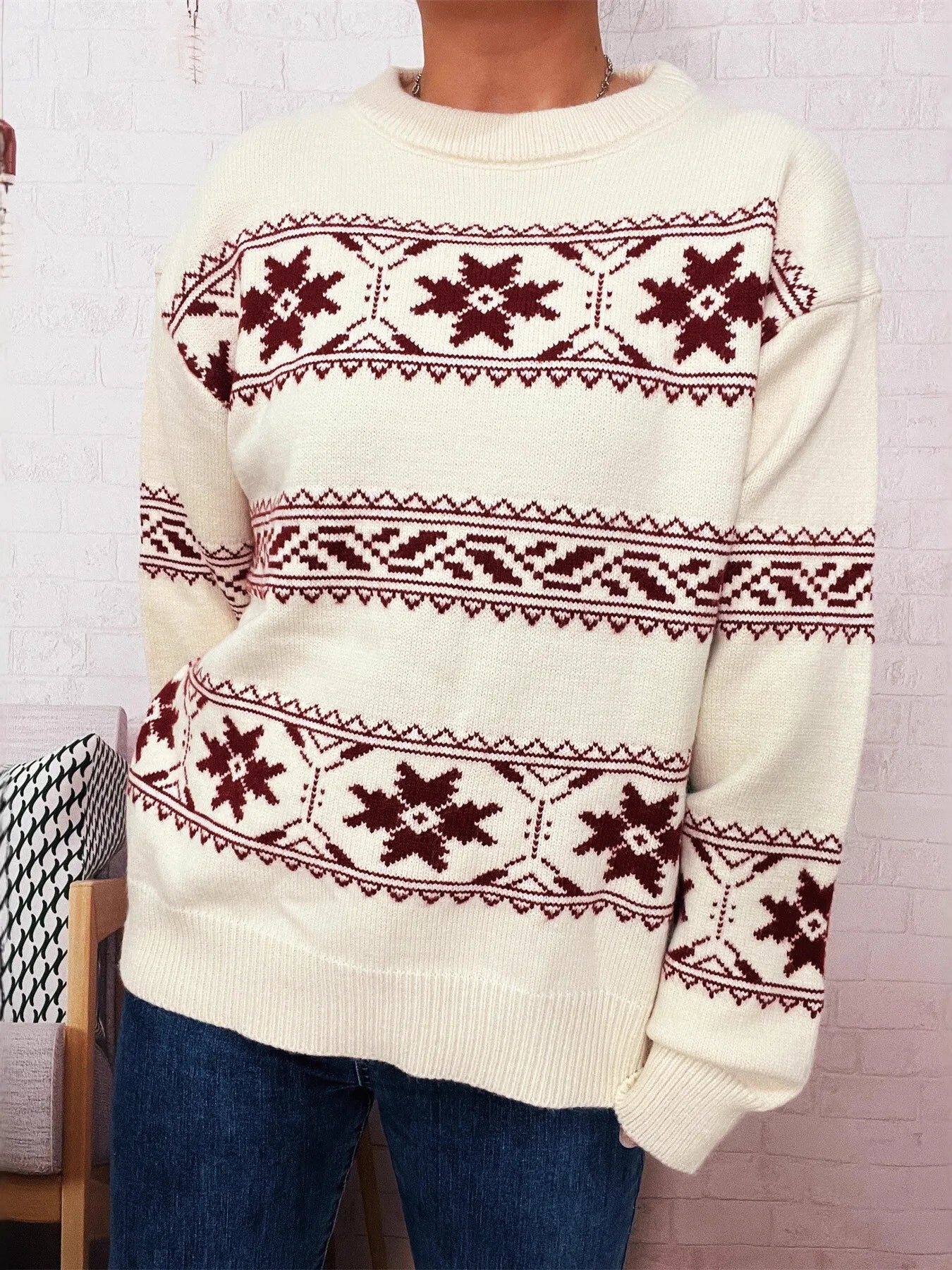 White crewneck sweater with red Fair Isle snowflake row and geometric stripe details