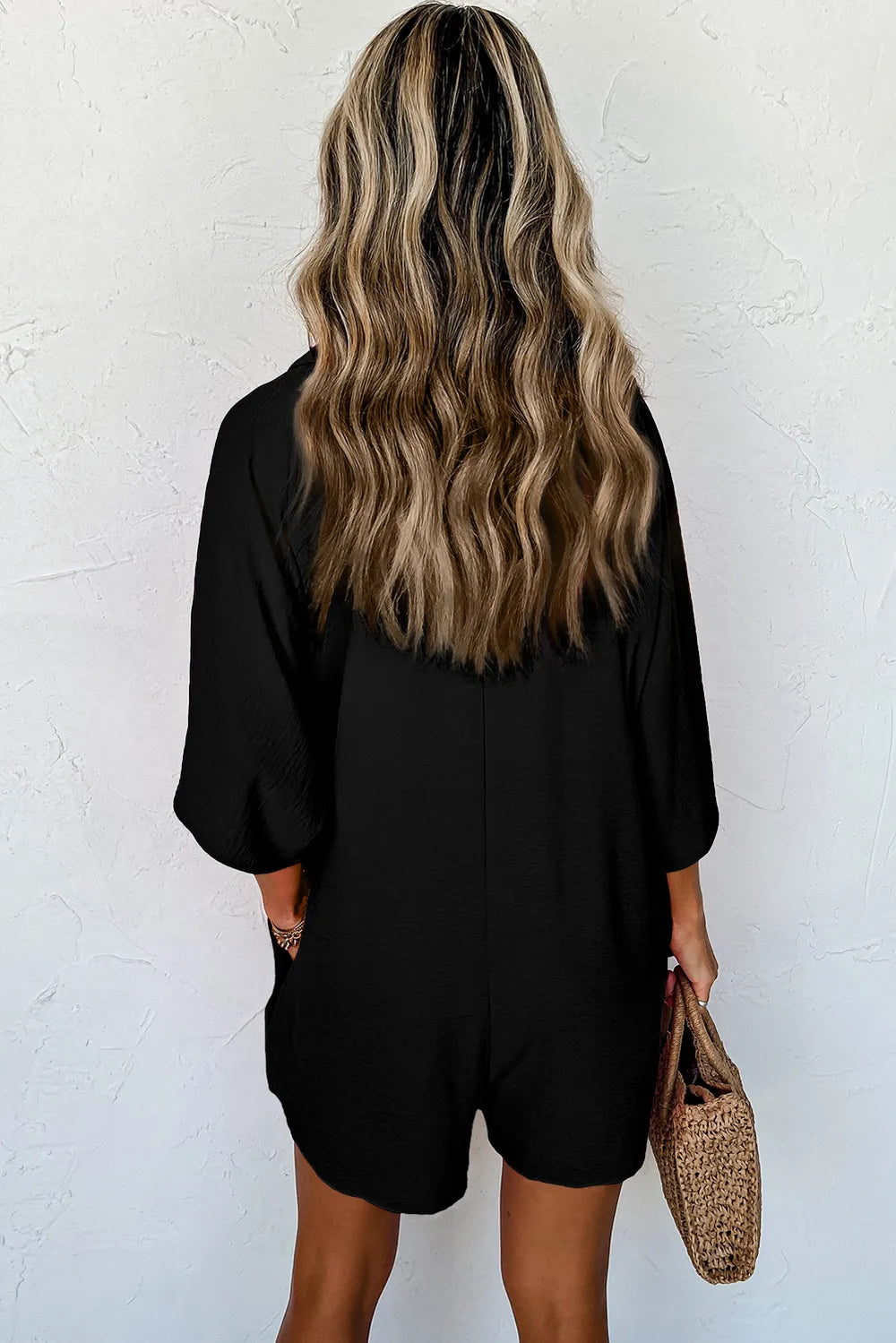 Black half-button collared neck romper, back view, short sleeves