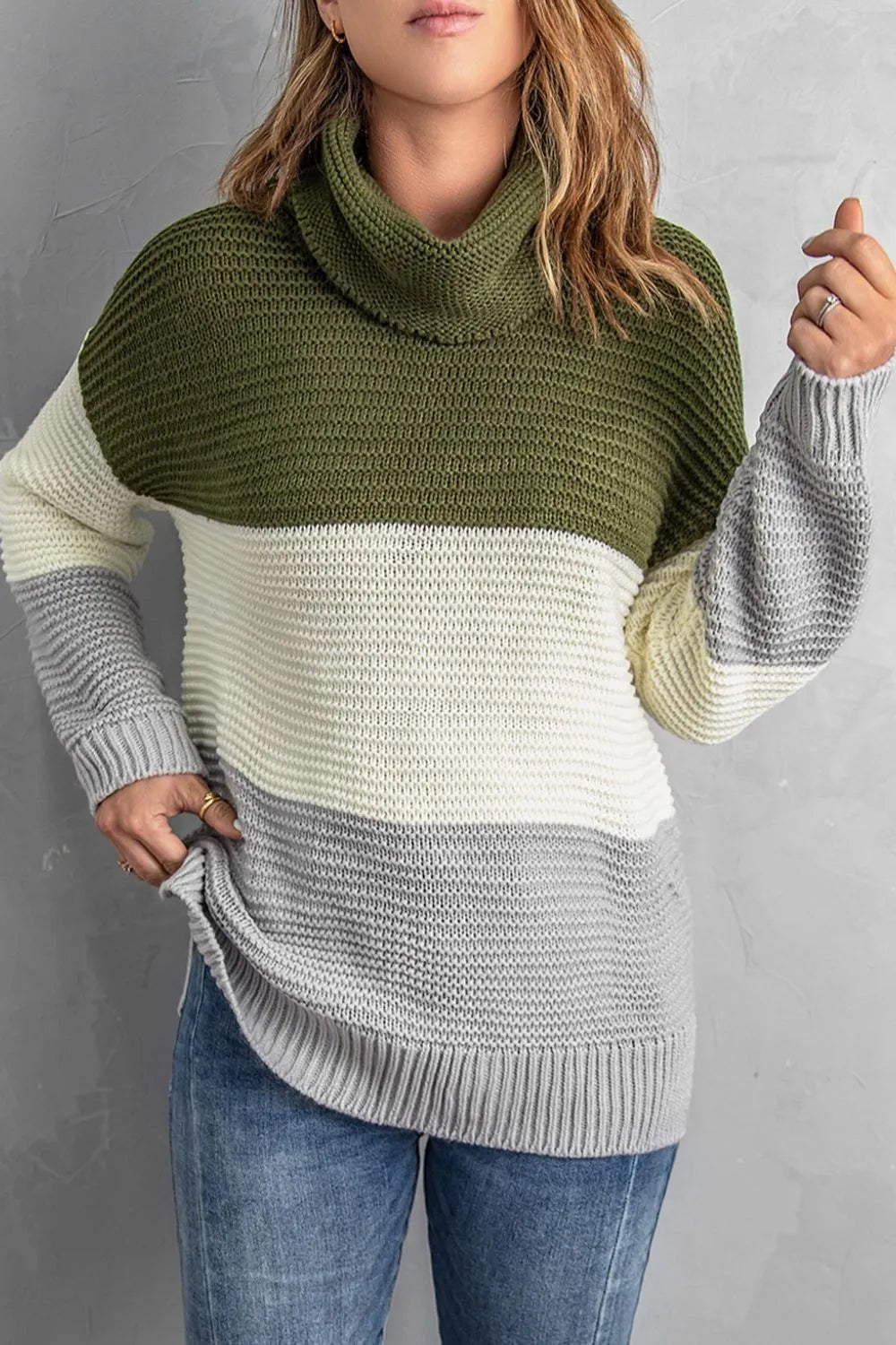 Color-block turtleneck sweater with moss green upper and cream/gray lower; long sleeves