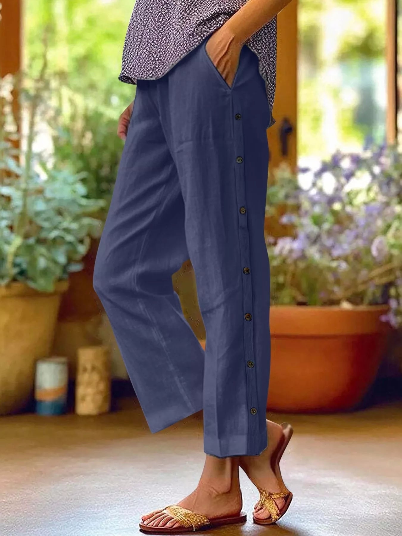 Navy blue polyester pants with side buttons and side pockets, relaxed fit
