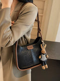 Adjustable Strap Shoulder Bag by Trendsi; black PU leather with brown trim, small size, bunny keychain attached.
