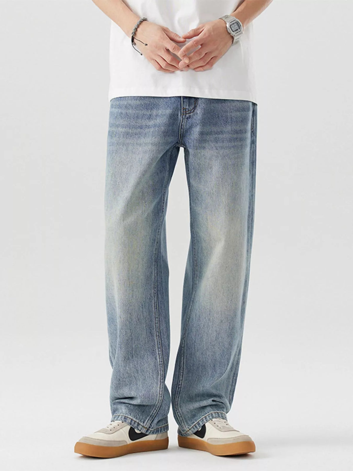 Blue vintage-wash loose-fit cotton jeans, front view with belt loops and fly