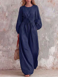 Smocked waist long-sleeve jumpsuit in dark blue, full-length wide-leg silhouette