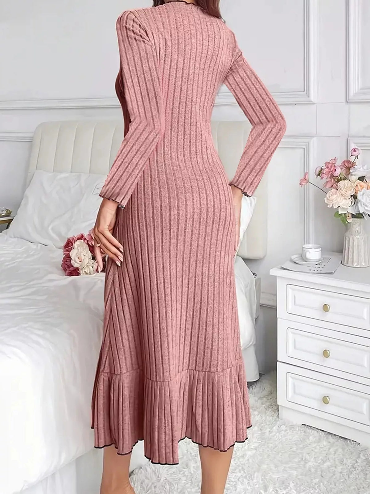Dusty pink ribbed knit bodycon dress with long sleeves and ruffle hem—back view
