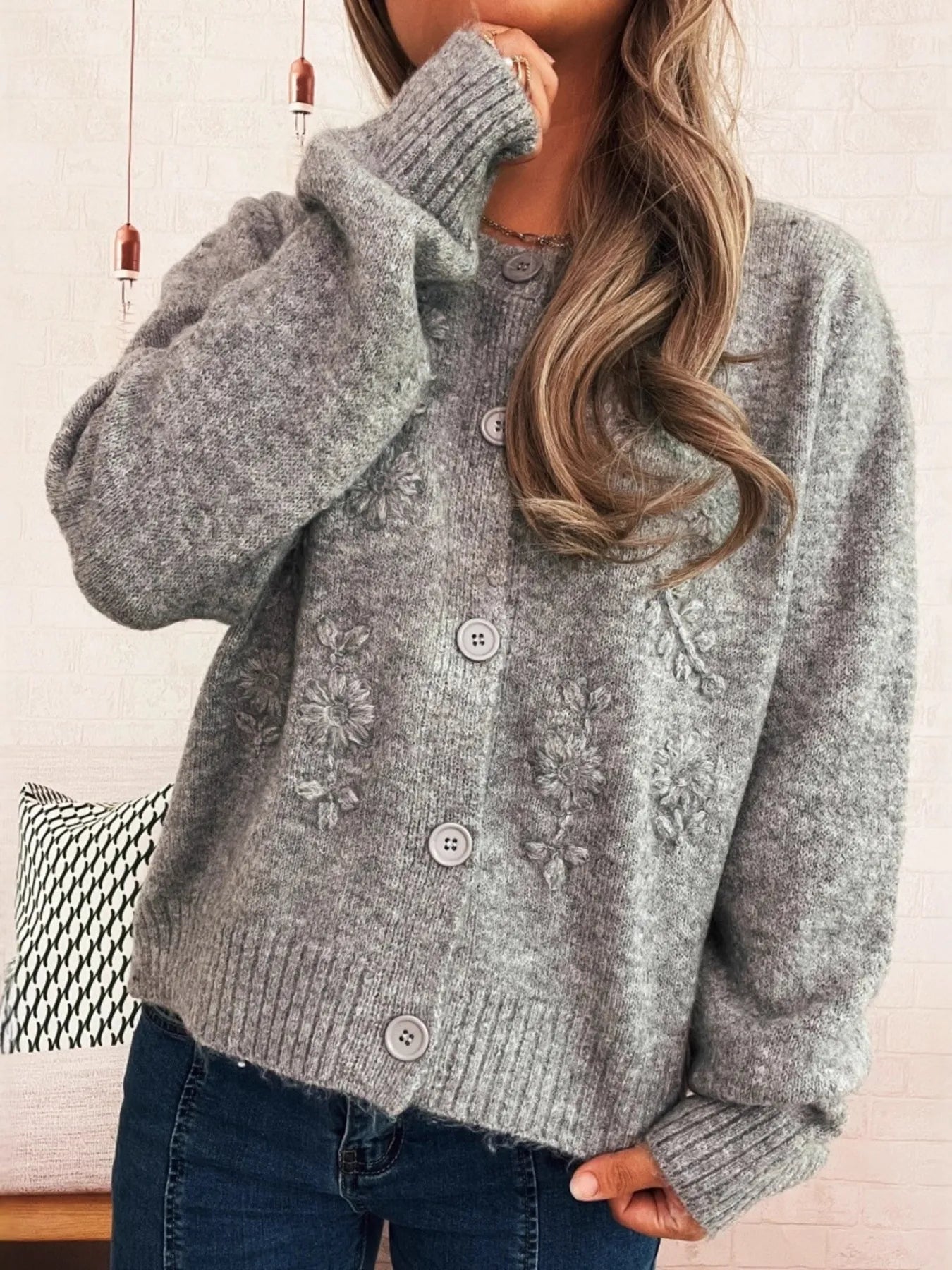 Gray ribbed-hem cardigan with flower embroidery and button front, long sleeves.