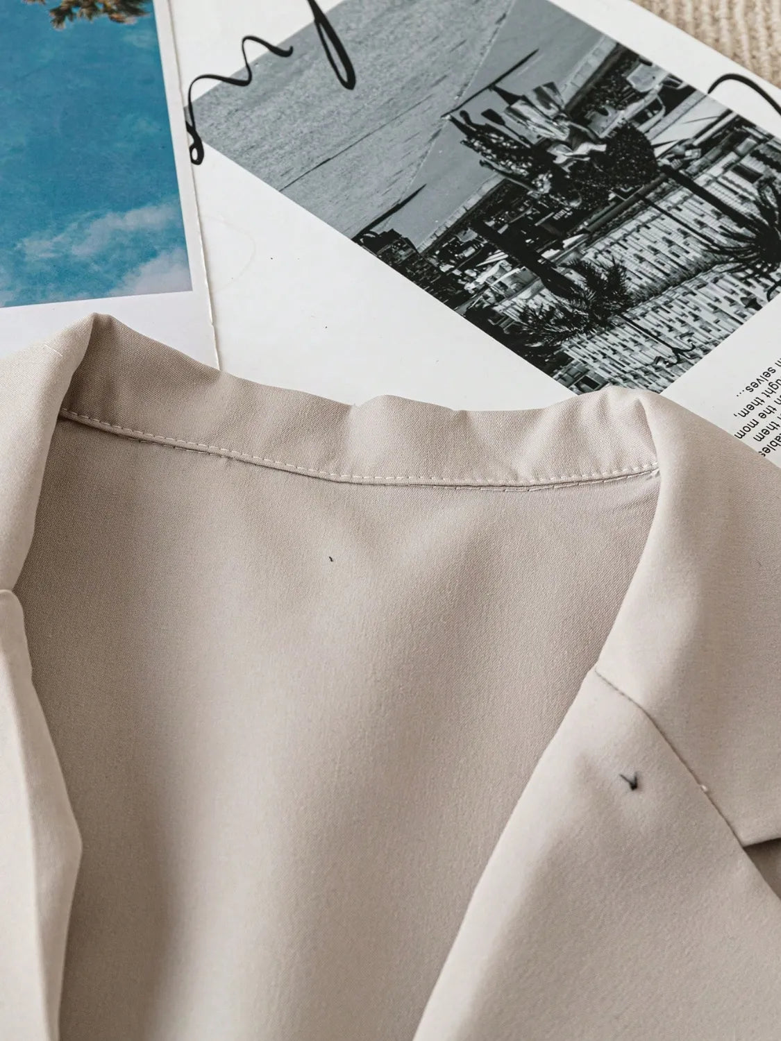 Light khaki blazer neckline with structured lapel and seam detail