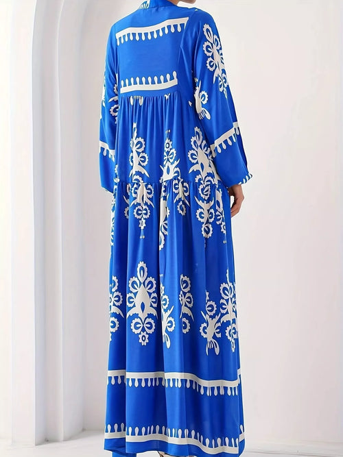 Blue long-sleeve maxi dress with white floral print and tiered skirt hem trim