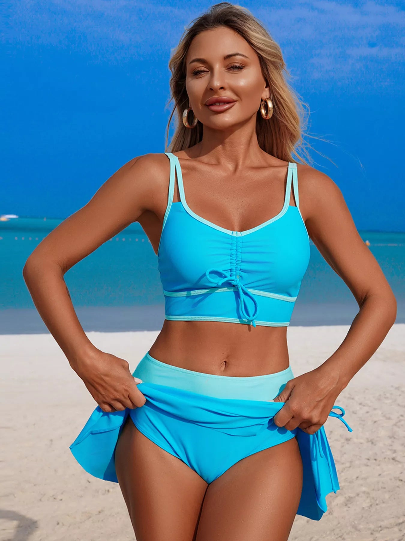 Two-piece turquoise swim set with contrast trim and drawstring top