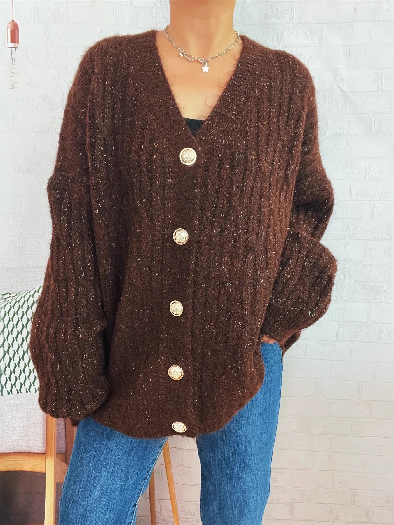 Brown cable-knit button-up cardigan with V-neck and front button closure