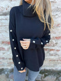 Dark navy turtleneck long sleeve sweater with button-detail cuffs and ribbed collar