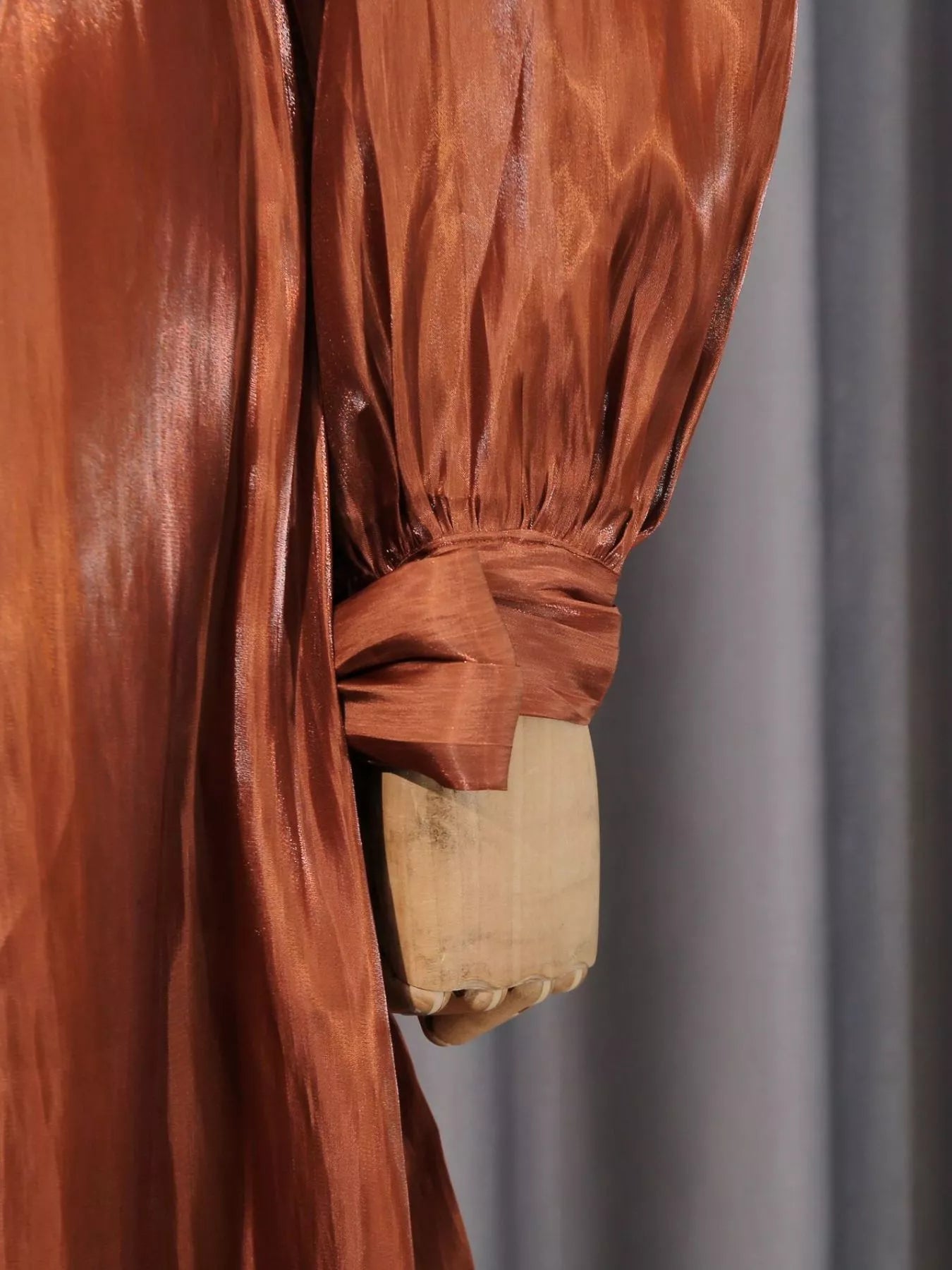 Cedar & Moore Front Twisted Draped Long Sleeve Maxi Dress in rust satin with ruched bodice and tied cuff