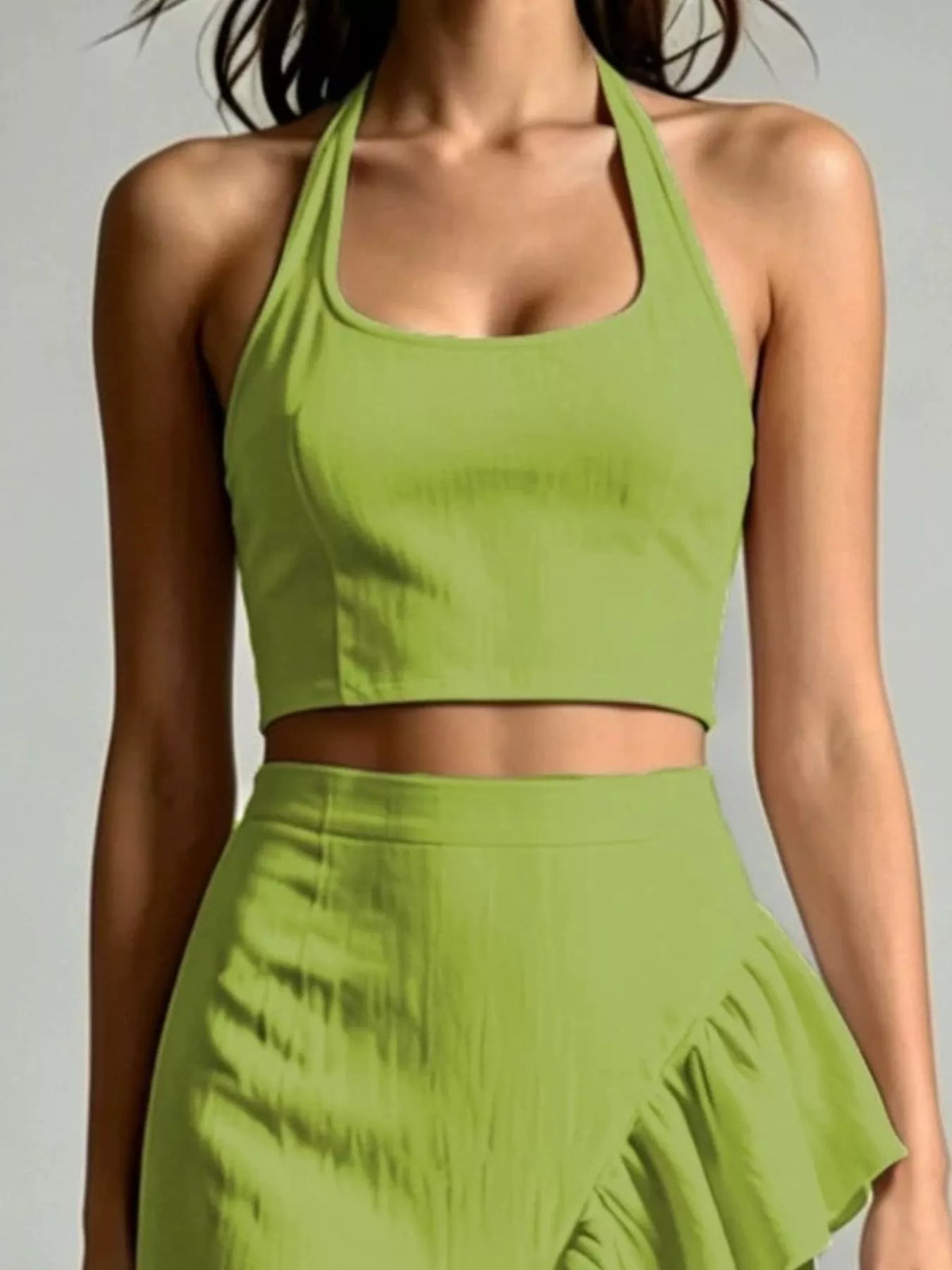 Green halter crop top with ruffled high-low maxi skirt