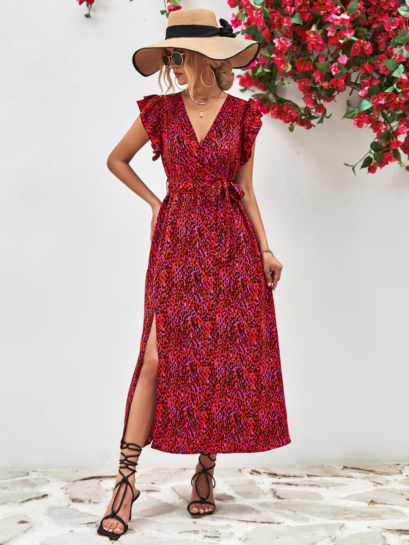 Red printed surplice neck flutter sleeve slit dress, midi length with side slit and V neckline.