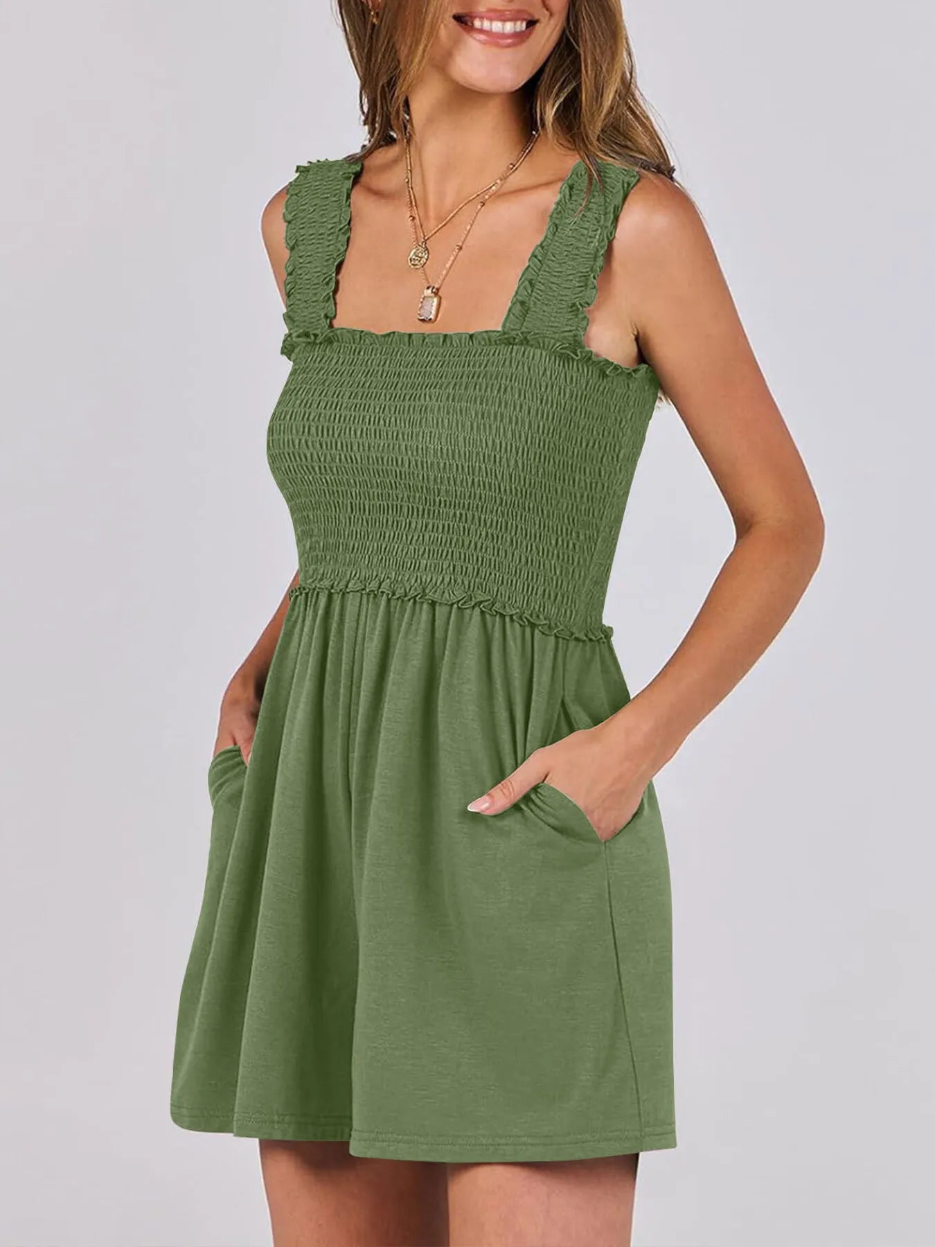 Emerald green smocked square-neck sleeveless romper with ruffled straps and flared skirt