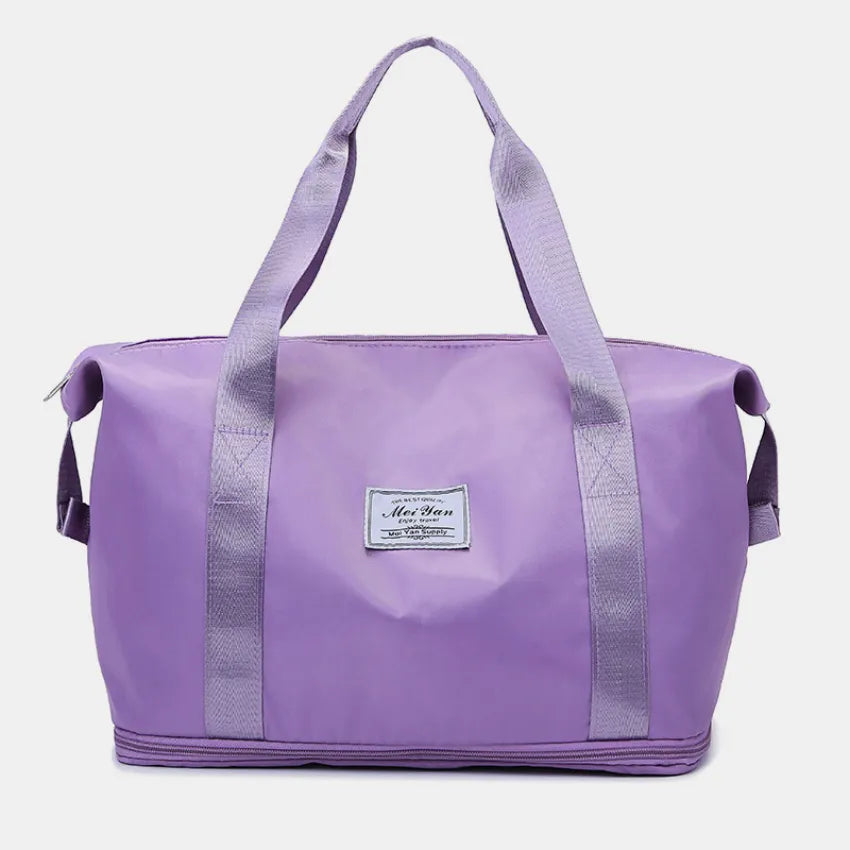 Lavender large duffle bag with long handles and front patch label