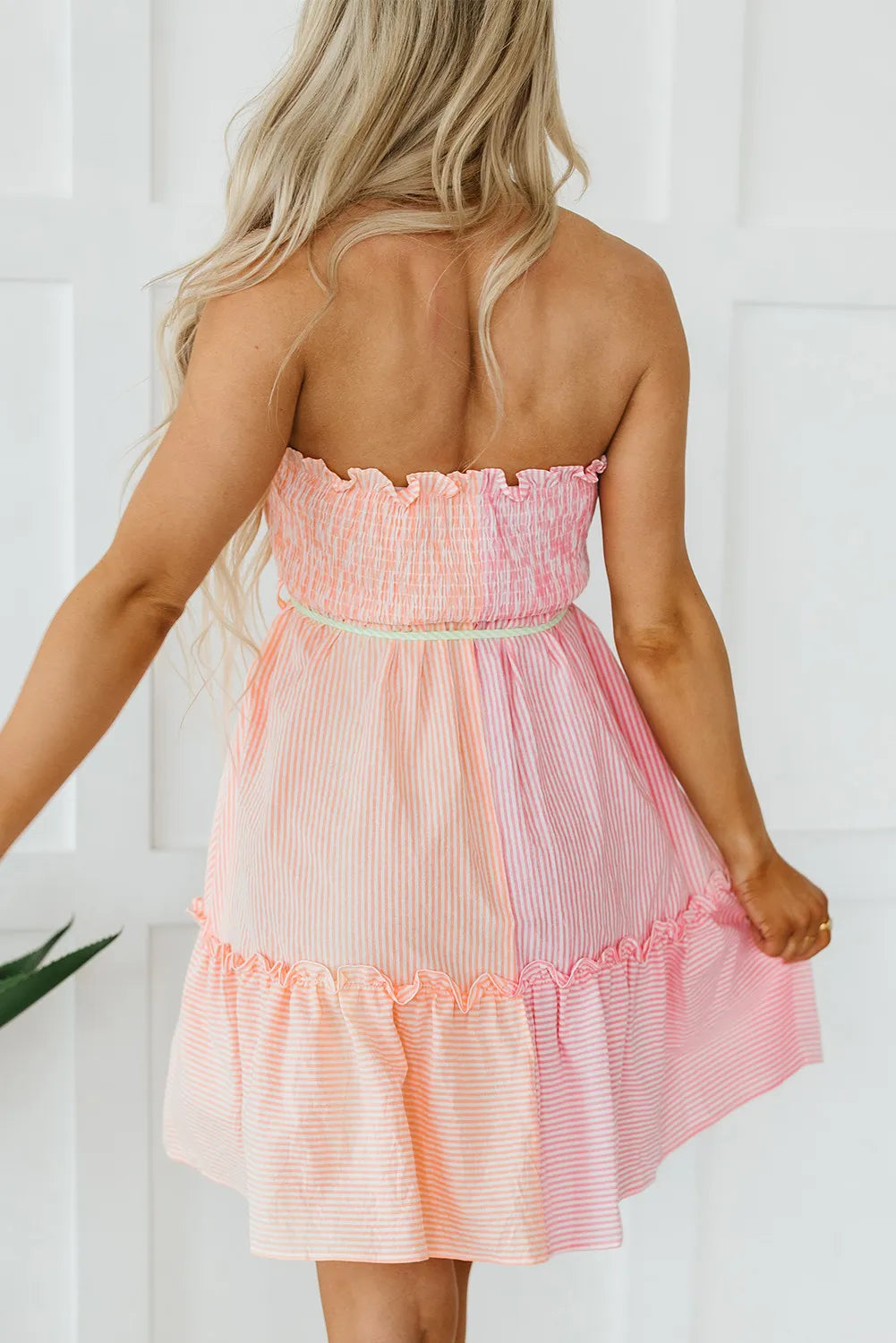 Trendsi Contrast Smocked Tube Mini Dress in peach-pink gradient striped with a ruffle hem