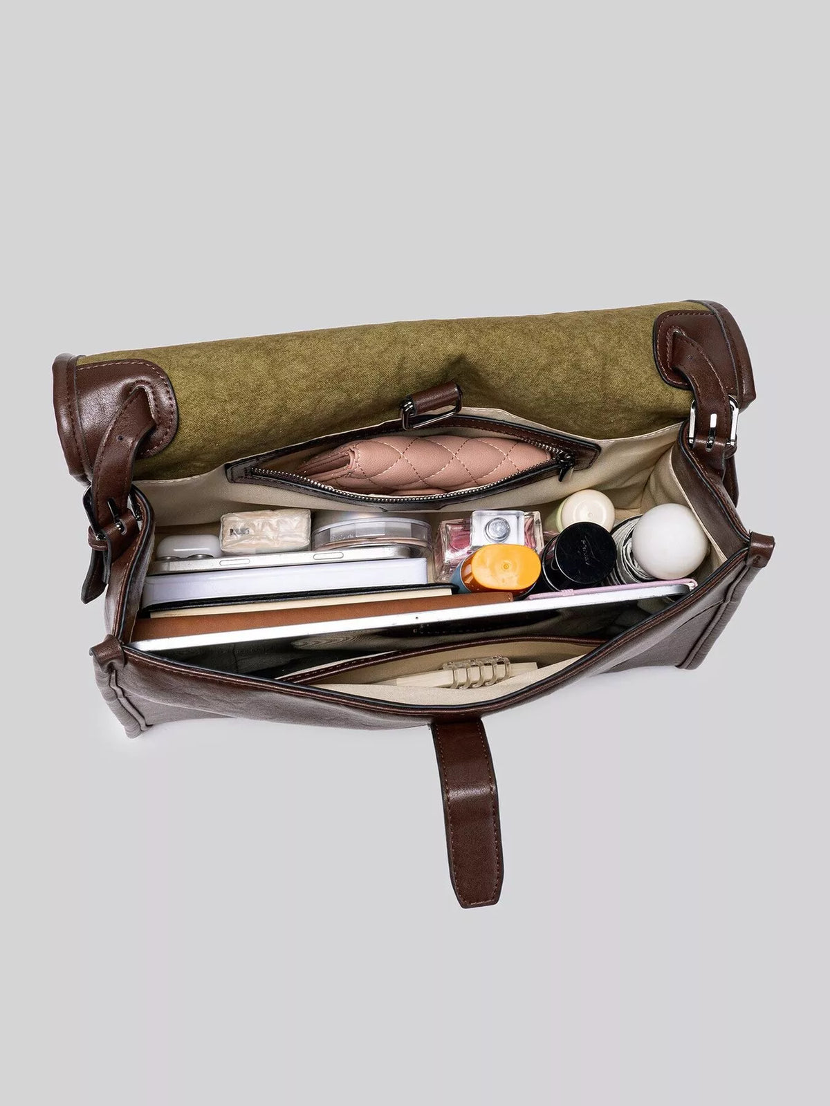 Brown messenger bag interior view showing organized compartments and soft lining