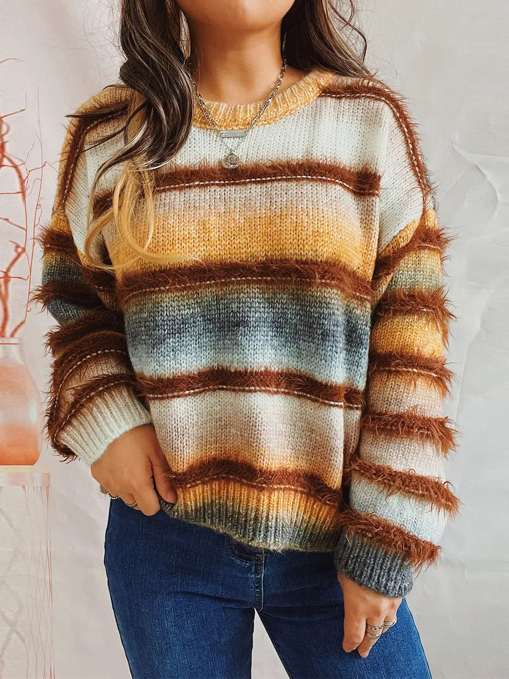 Striped round-neck long-sleeve sweater with brown, tan, white, and gray horizontal bands