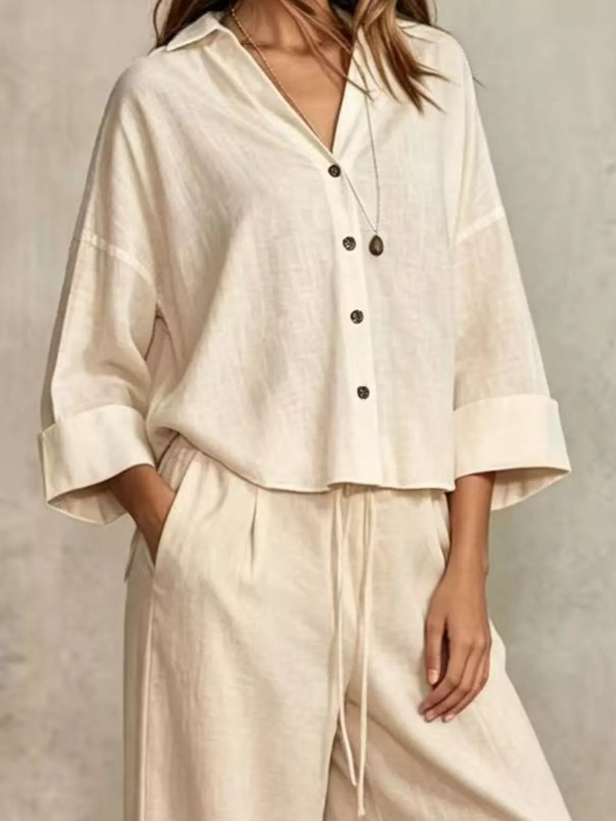 Beige button-down shirt and wide-leg pants set, V-neckline, 3/4 sleeves, buttons.