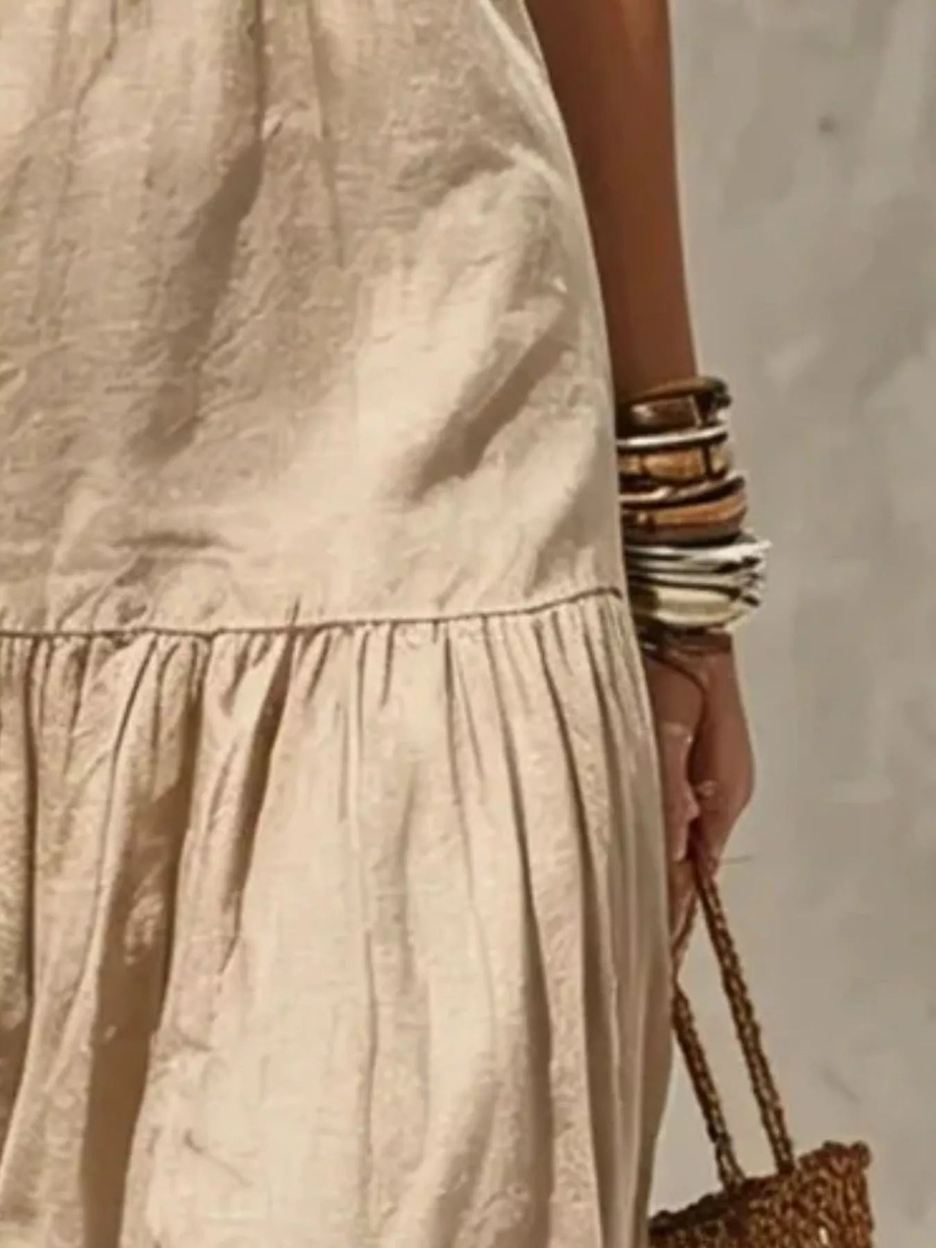 Close-up of khaki tiered maxi skirt with gathered ruffle hem and soft drape.