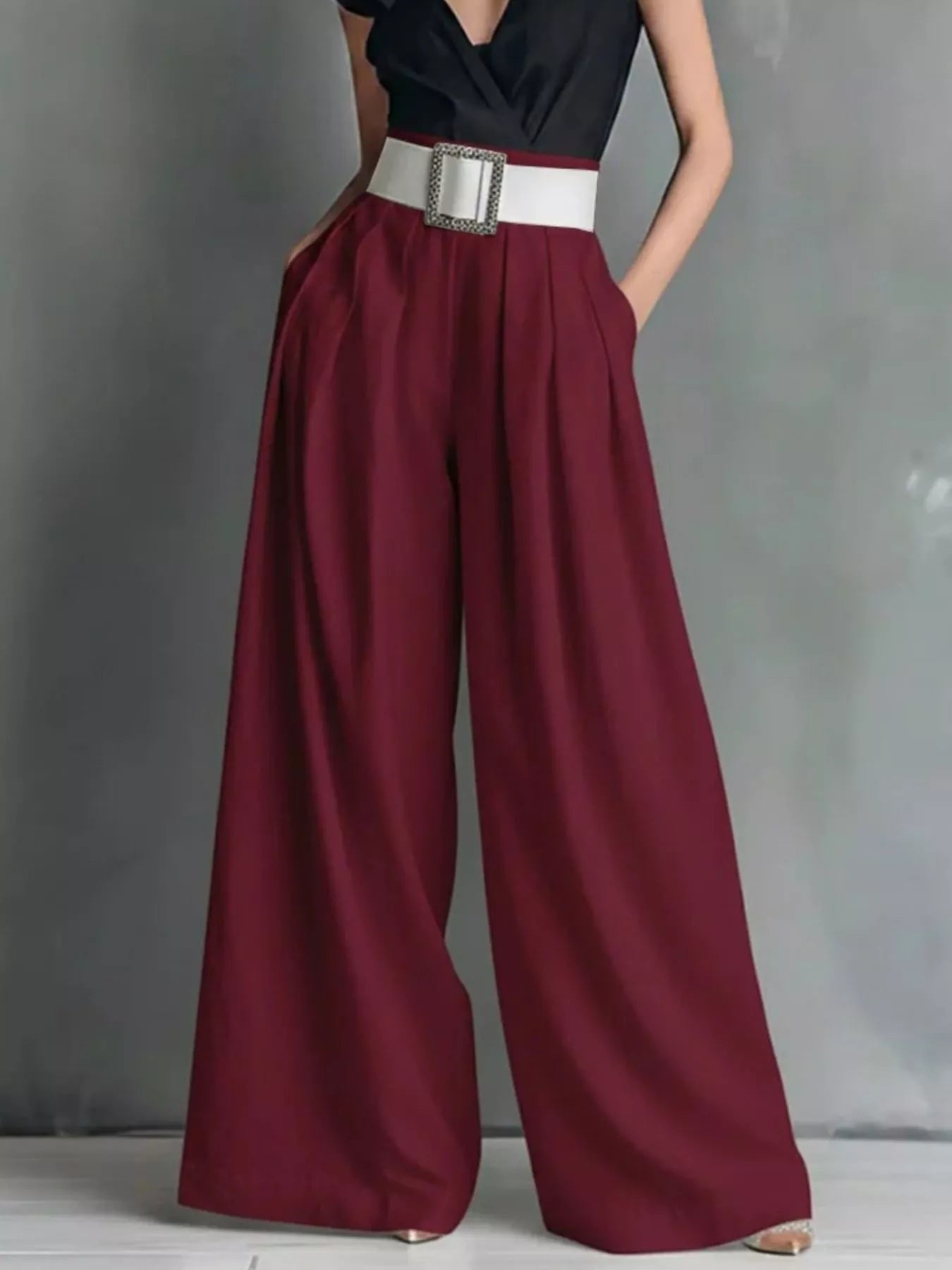 Burgundy high-waisted wide-leg pants with sculpted belt and square buckle