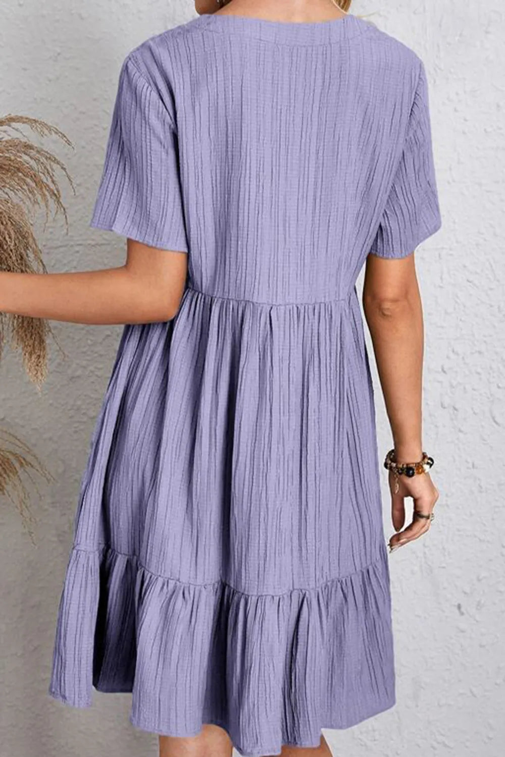 Lavender V-neck short-sleeve dress, back view, gathered waist and tiered skirt
