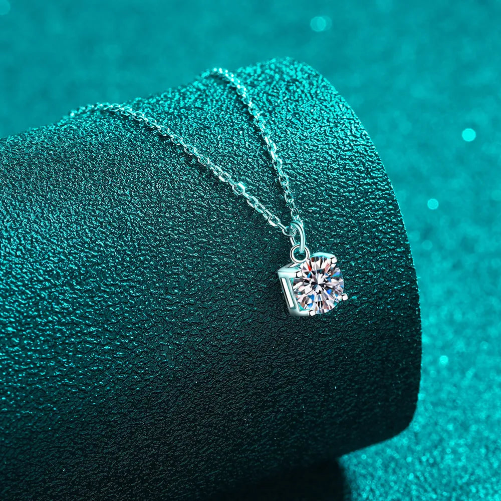 Round moissanite pendant in prong setting on sterling silver chain