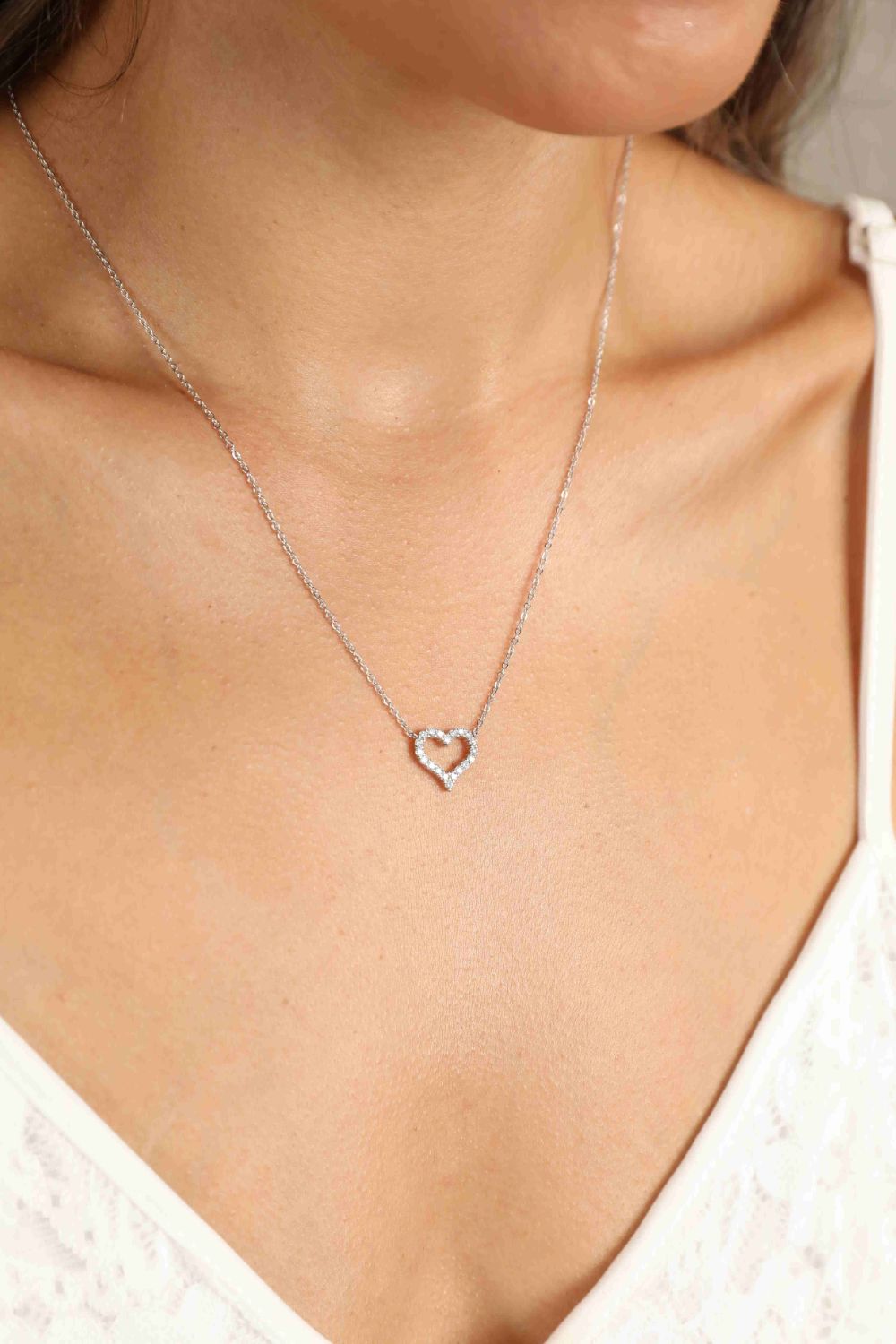 Heart pendant necklace with small pavé stones on a fine silver chain