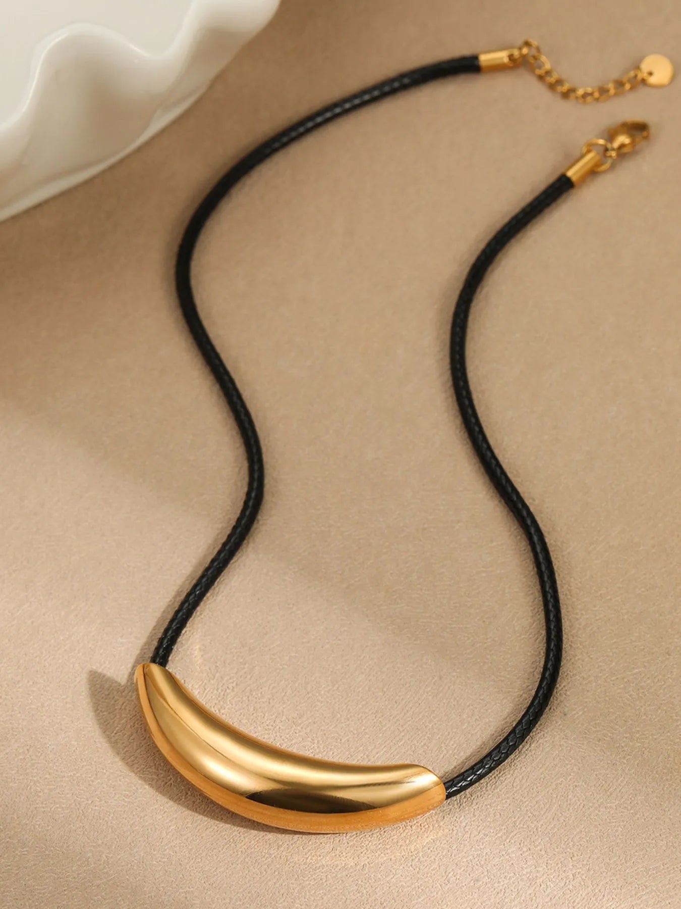Curved bar pendant necklace with black leather rope and gold finish