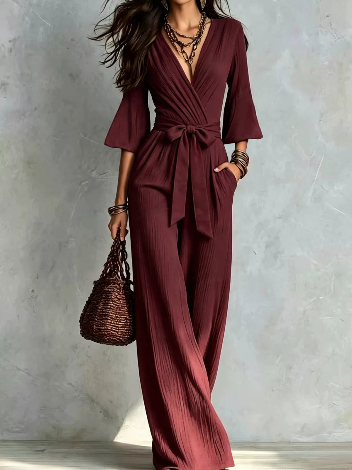Burgundy pleated tie-waist wide-leg jumpsuit with pockets and V-neck