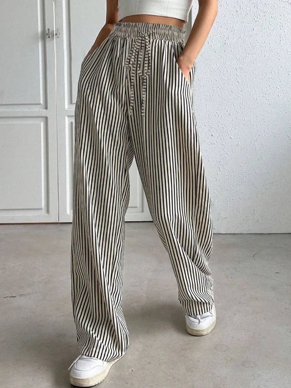 Striped elastic waist drawstring pants in black and white, full length, loose fit