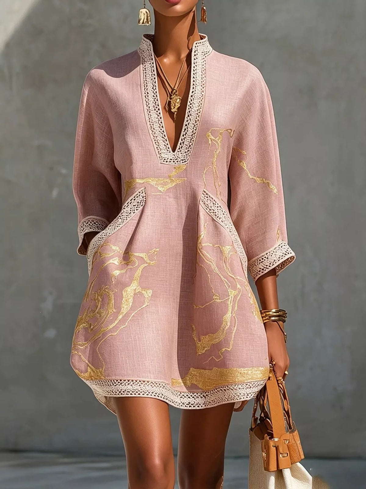 Pink relaxed-fit mini dress with notched V neckline, lace trim, and gold horse-print design