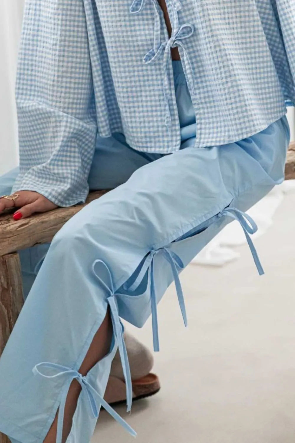 Light blue side-tied pants with pocket slits and waistband drawstring
