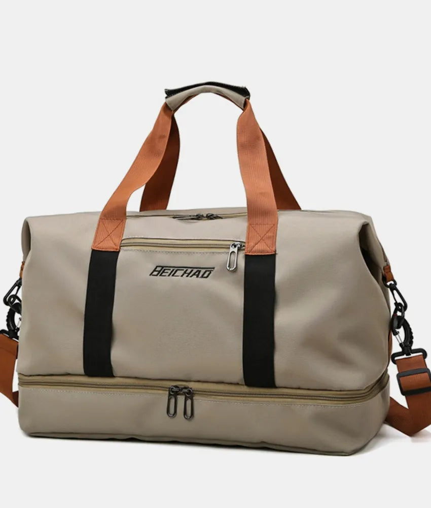 Oversize travel duffle bag in beige with black side stripe and tan carry handles