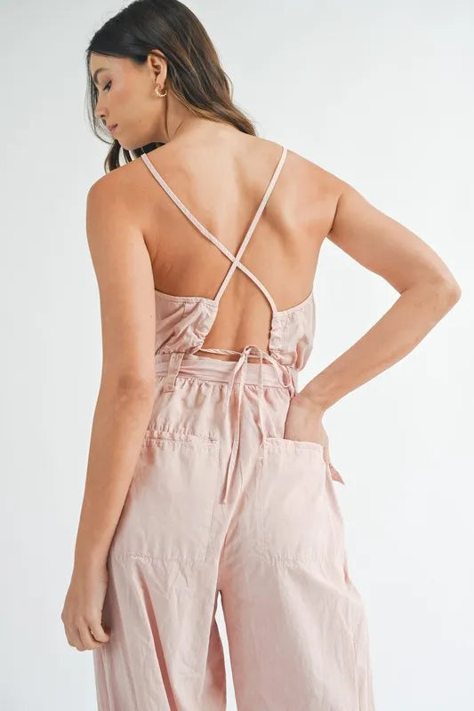 Pink jumpsuit back with crisscross spaghetti straps and tied waist detail