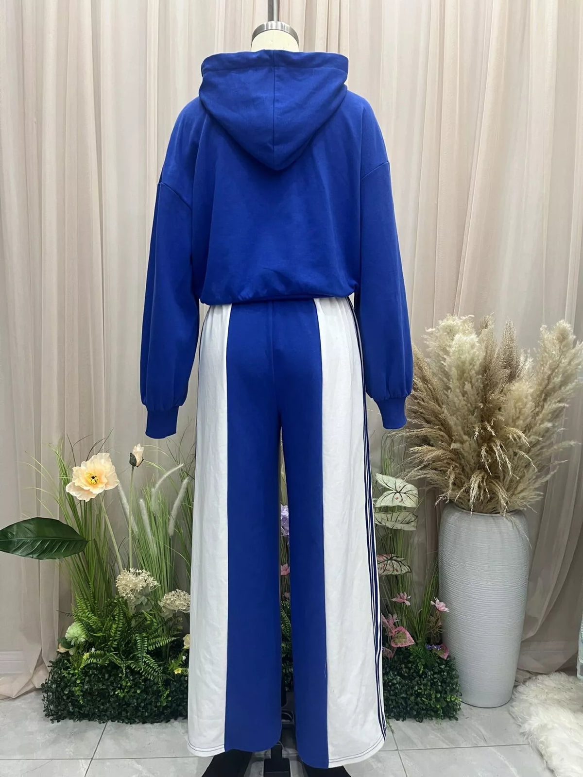 Blue zipless hoodie and wide-leg pants set with white side panels and drawstring waist