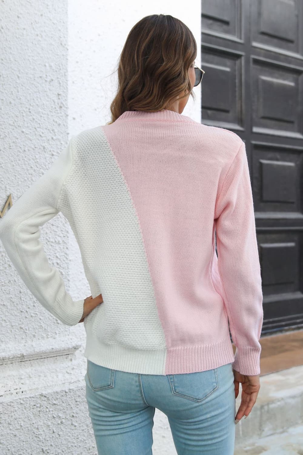 Back view of contrast color long-sleeve sweater, blush pink with white diagonal panel