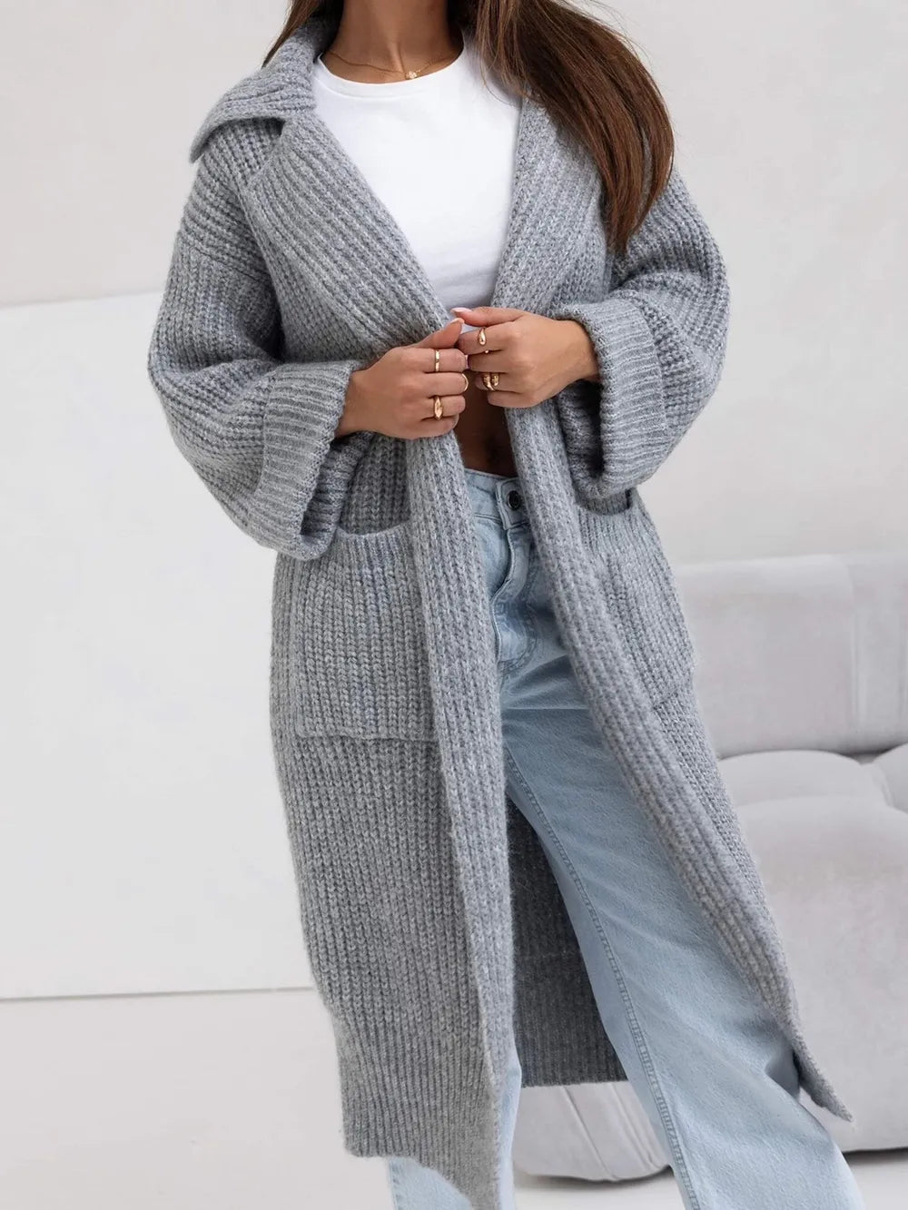 Gray long cardigan sweater with collared neck, dropped shoulders, and side pockets