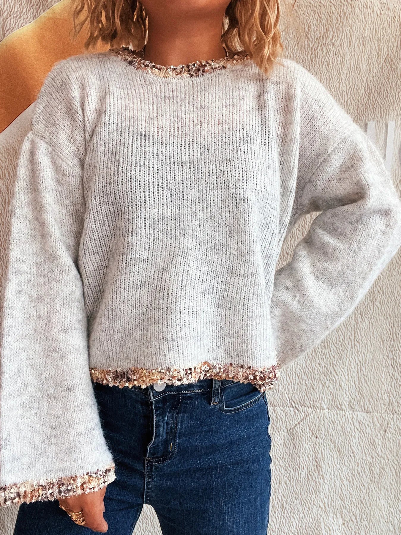 Light gray cropped round-neck knit sweater with sparkly cuff trim, front view