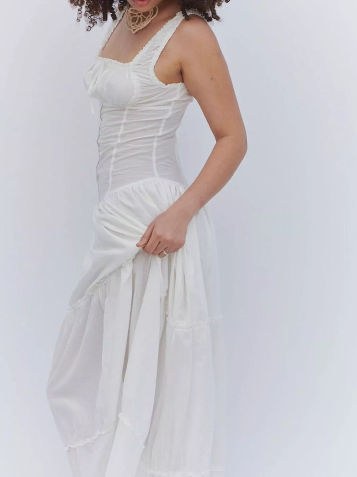 White cotton maxi dress with sleeveless smocked bodice and layered tiered skirt