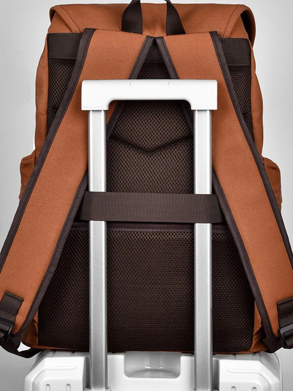 Open canvas backpack showing mesh back panel and padded shoulder straps