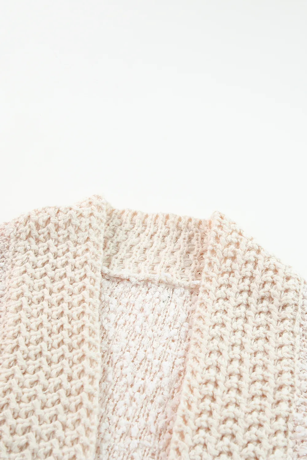 Cream cardigan knit close-up with open-front seam and textured stitching