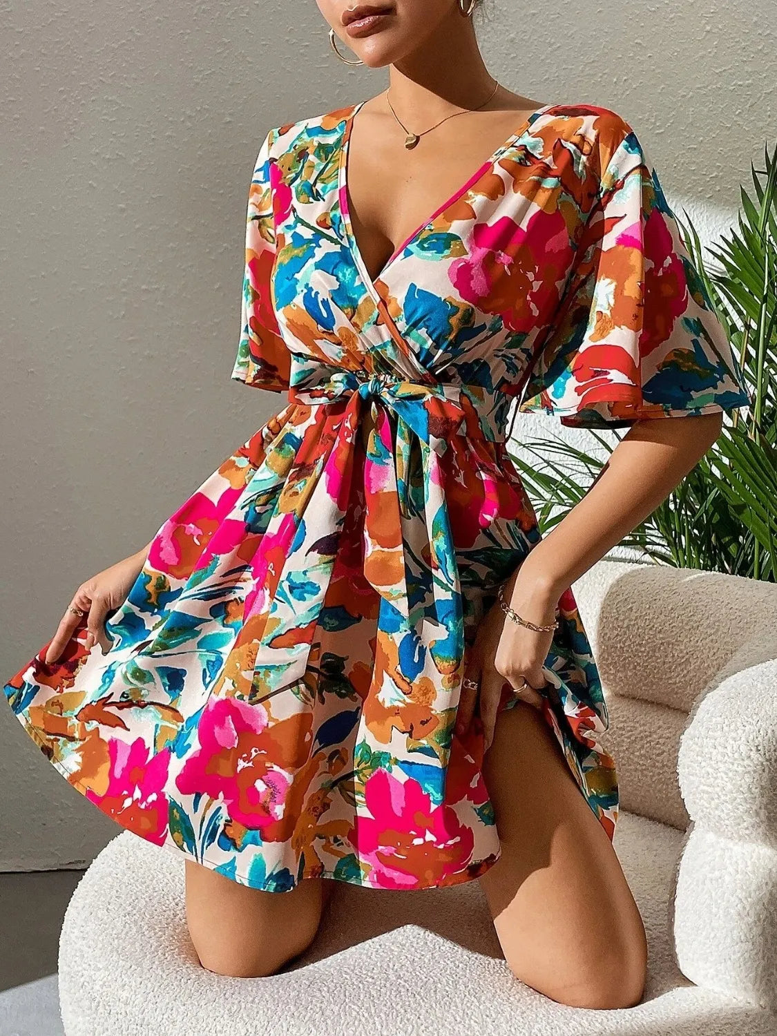 Printed surplice short-sleeve mini dress with a tie waist, bold multicolor floral print by Trendsi brand