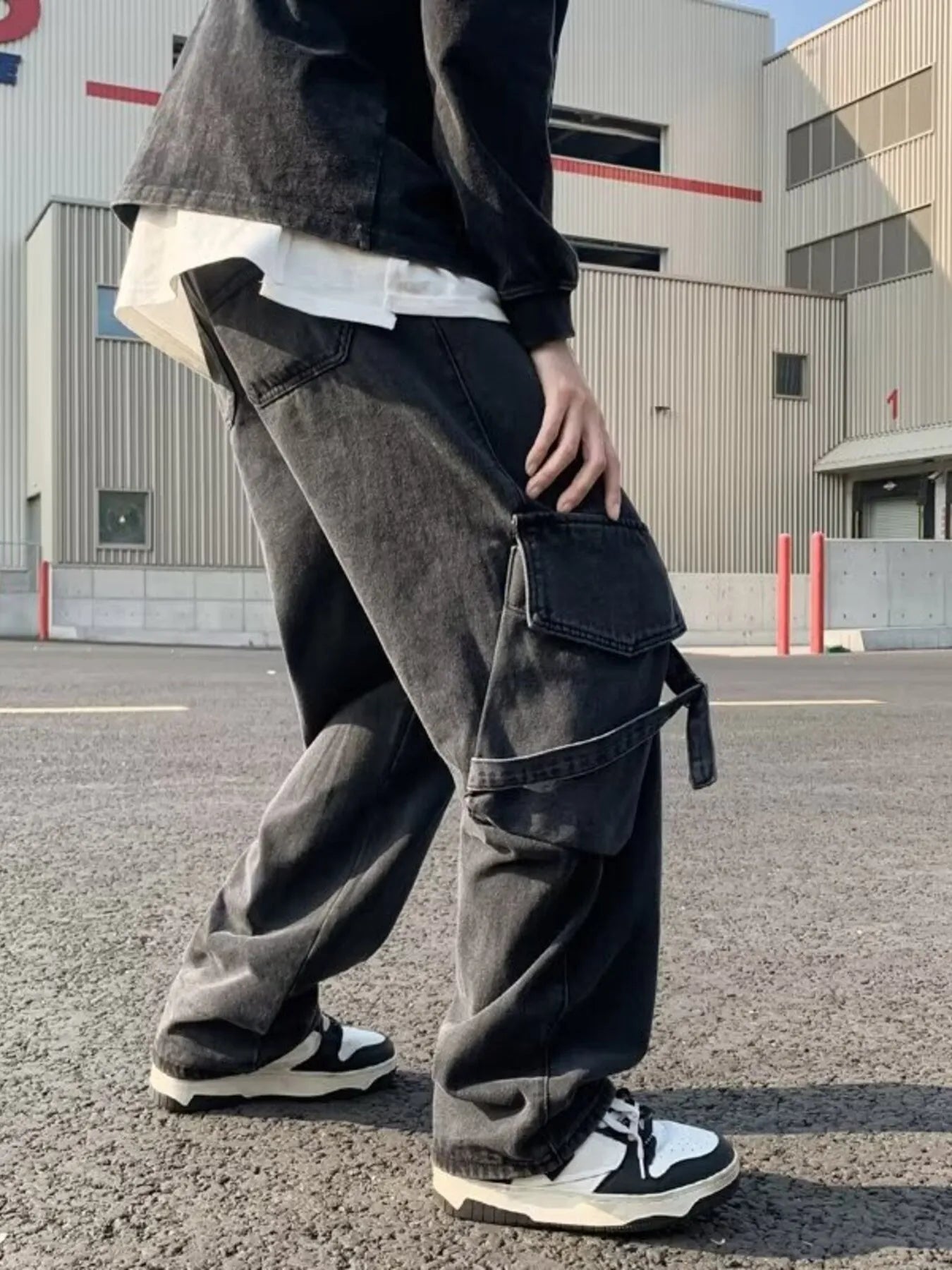 Black wide-leg cargo jeans with drawstring waist, front cargo flap pockets and belt loops