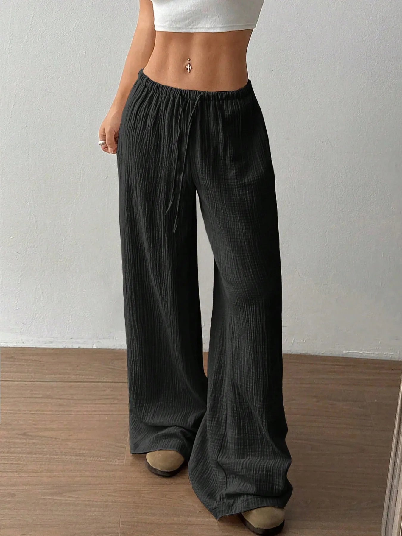 Black wide-leg casual pants with elastic waistband and drawstring, full-length front.
