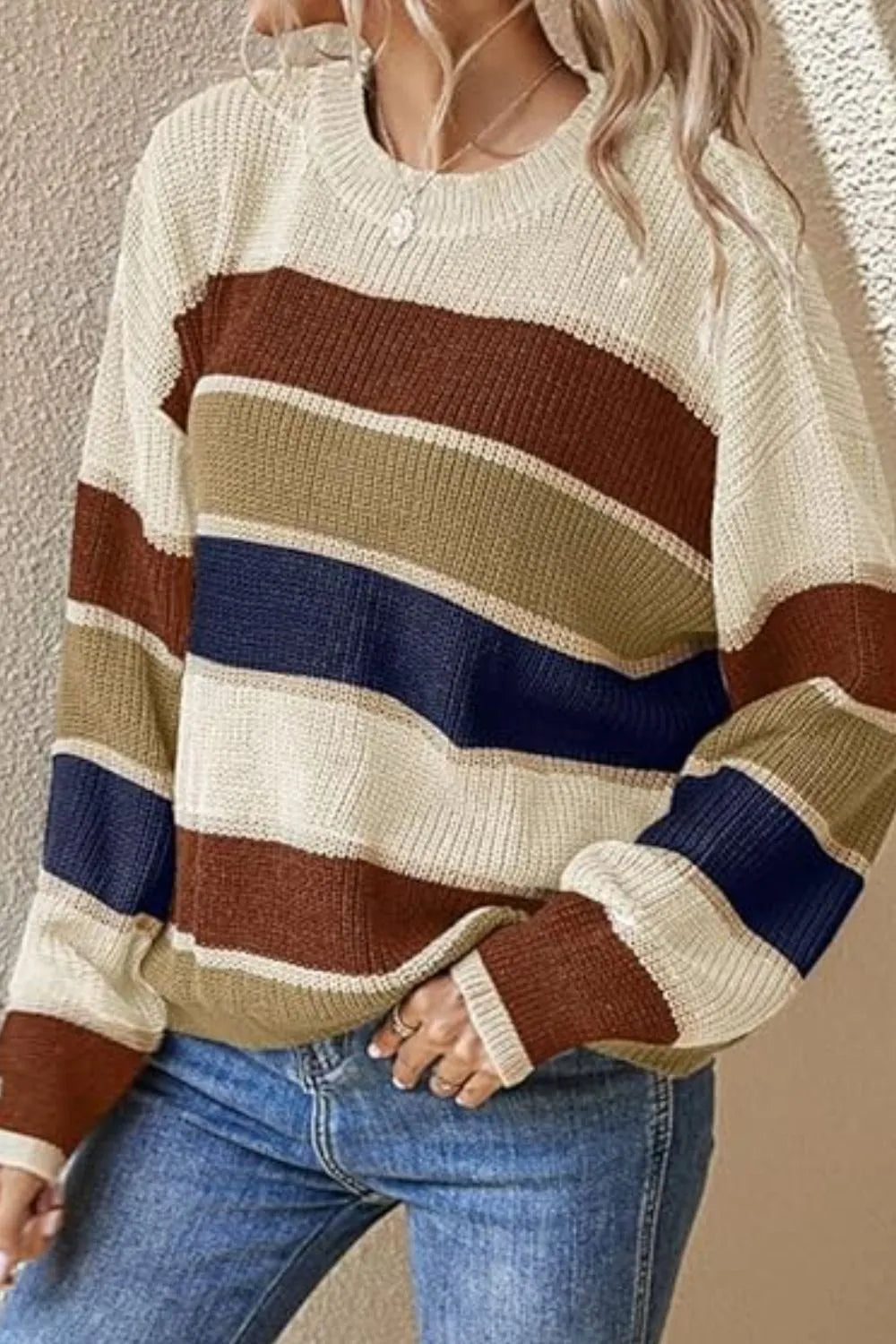 Striped round-neck long-sleeve sweater in cream with brown, navy, and tan horizontal bands