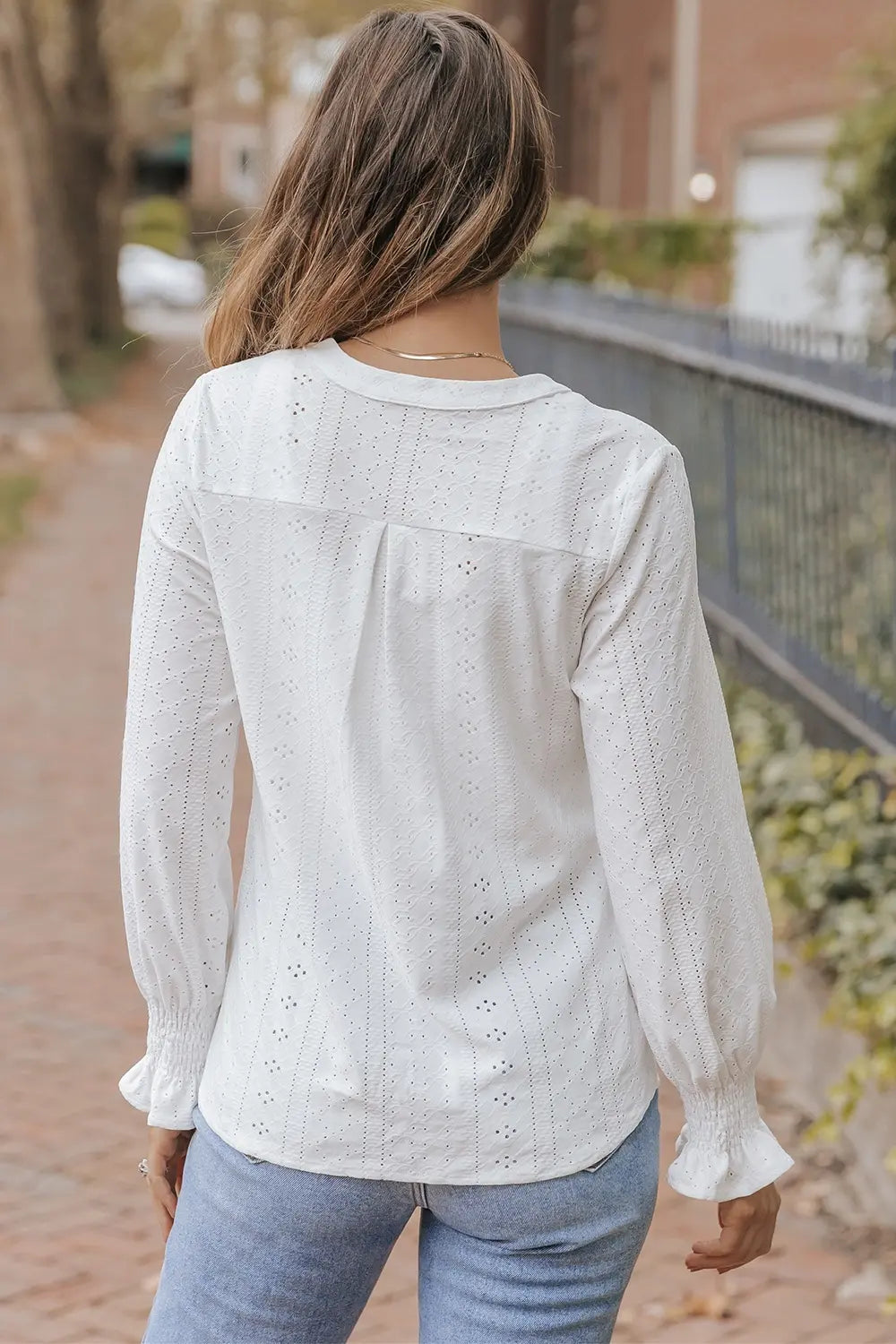 White openwork long-sleeve blouse, back view with yoke and button detail
