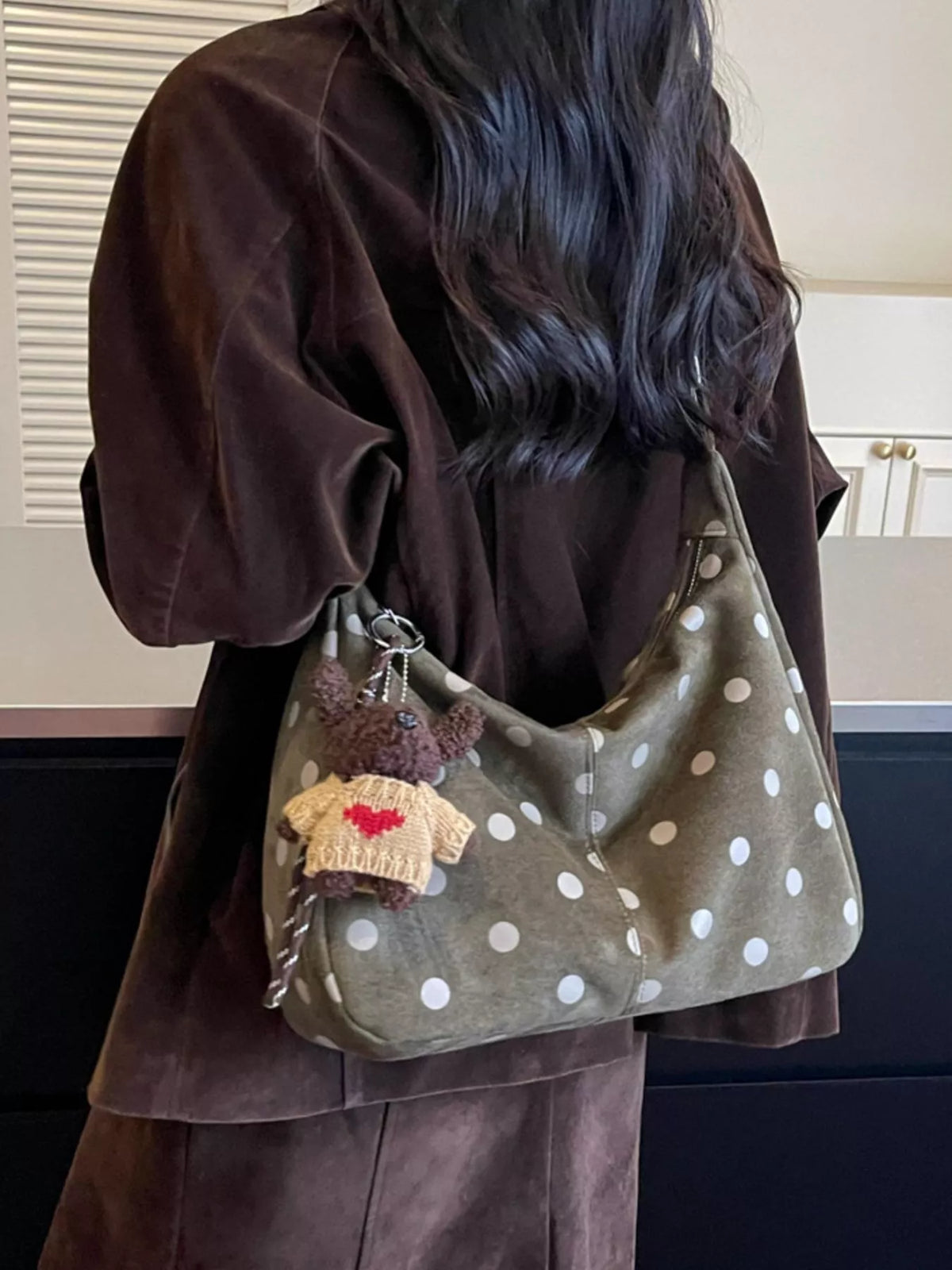 Green suede polka-dot shoulder bag with teddy charm and stitched front pocket detail